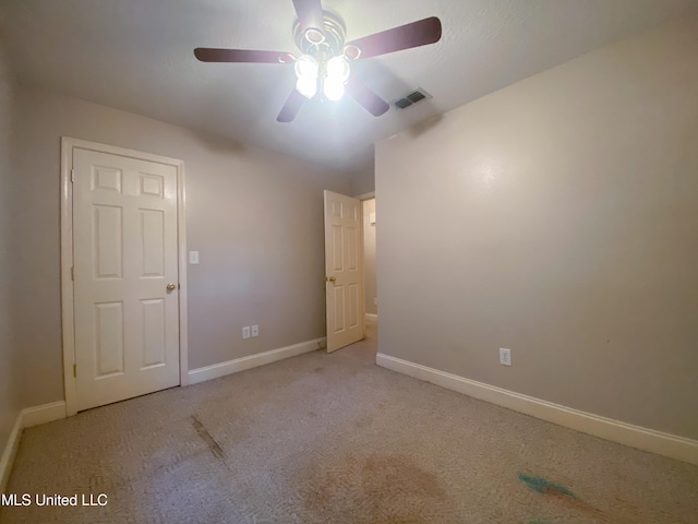 carpeted empty room with ceiling fan