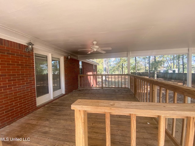 wooden terrace featuring ceiling fan