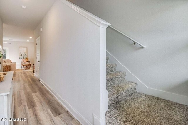 staircase with wood-type flooring