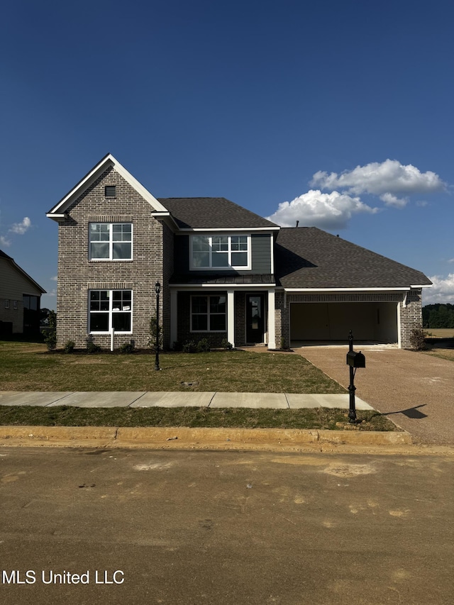 13596 Broadmore Ln, Olive Branch, MS 38654 - traditional-style house with a front lawn, driveway, an attached garage, and brick siding
