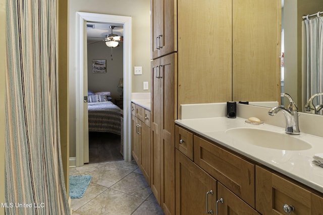 ensuite bathroom with vanity, ensuite bathroom, a ceiling fan, and tile patterned floors