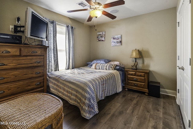 bedroom with ceiling fan, dark wood finished floors, visible vents, and baseboards