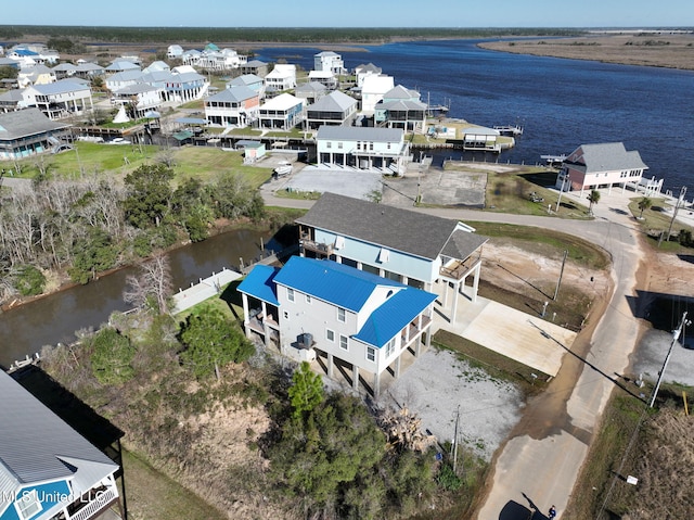 birds eye view of property featuring a water view and a residential view