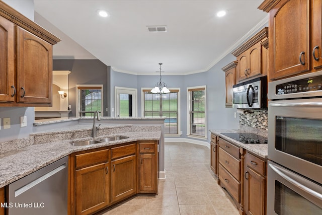 kitchen featuring sink, hanging light fixtures, crown molding, a chandelier, and appliances with stainless steel finishes