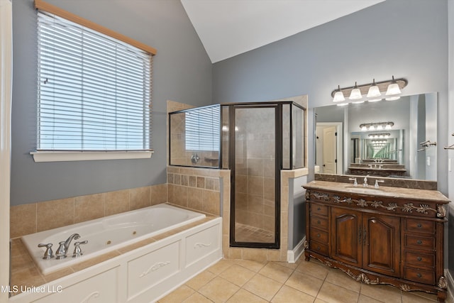 bathroom with tile patterned floors, vanity, vaulted ceiling, and separate shower and tub