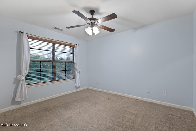 spare room with ceiling fan and carpet floors