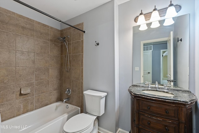 full bathroom featuring toilet, vanity, and tiled shower / bath combo