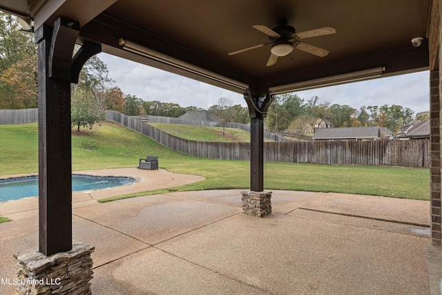 view of patio / terrace featuring ceiling fan and a fenced in pool