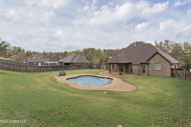 view of swimming pool with a patio area and a lawn