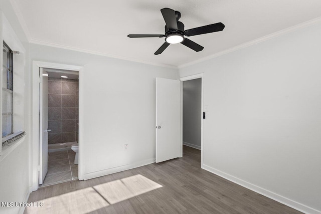 203 Bruin Ave, Pearl, MS 39208 - unfurnished bedroom featuring wood finished floors, crown molding, baseboards, ensuite bathroom, and a ceiling fan