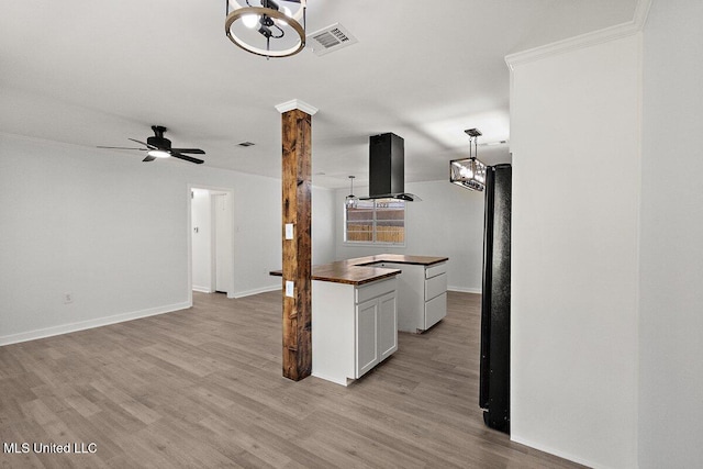 203 Bruin Ave, Pearl, MS 39208 - kitchen with wall chimney range hood, light wood-style floors, baseboards, a ceiling fan, and open floor plan