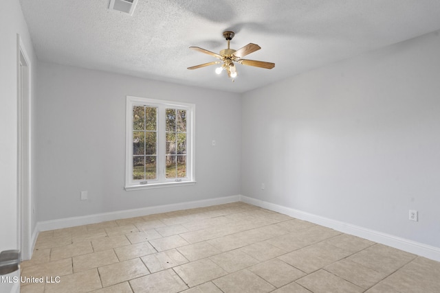 tiled spare room featuring ceiling fan and a textured ceiling