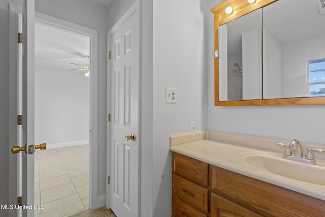 bathroom with ceiling fan, tile patterned flooring, vanity, and a textured ceiling