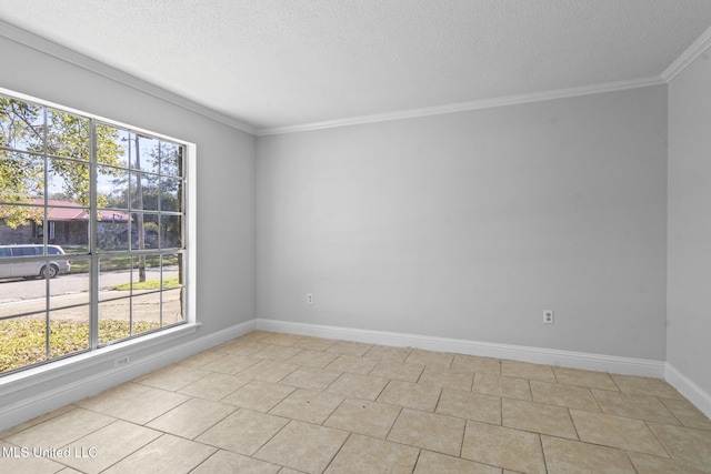 tiled empty room featuring a textured ceiling and ornamental molding