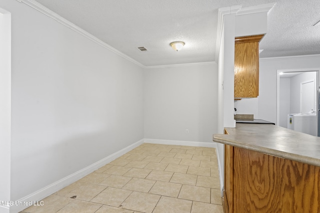 interior space with ornamental molding, a textured ceiling, and light tile patterned floors