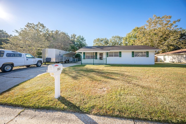 ranch-style house featuring a front yard, a porch, and a carport