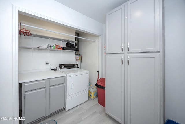 washroom featuring cabinets, washer / dryer, and light hardwood / wood-style flooring