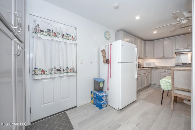 kitchen featuring gray cabinetry, ceiling fan, light hardwood / wood-style floors, and white appliances