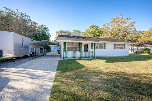 view of front of house featuring a carport, a porch, and a front yard