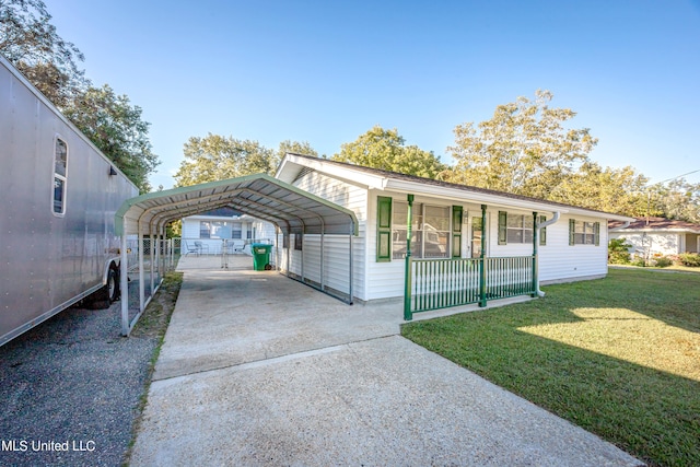 exterior space featuring a carport, a porch, and a front yard