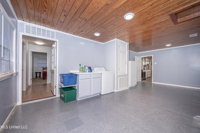 laundry area featuring washer / dryer, wood ceiling, crown molding, and wooden walls