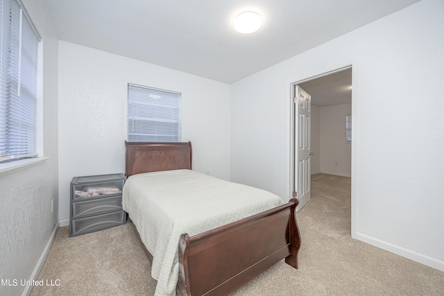 bedroom featuring light carpet