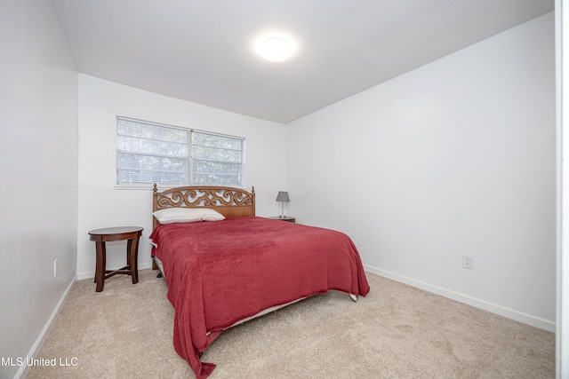 bedroom featuring light colored carpet