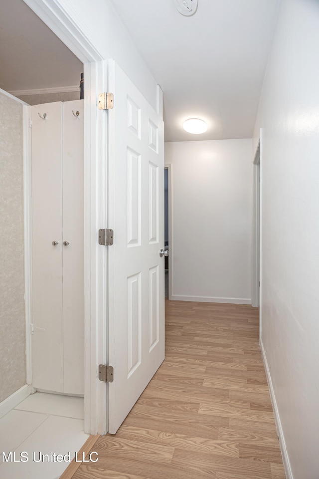 hall with light hardwood / wood-style flooring