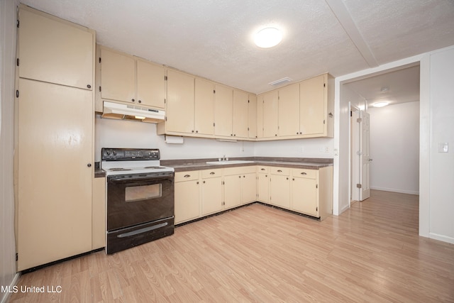 kitchen with cream cabinetry, a textured ceiling, light wood-type flooring, and electric stove