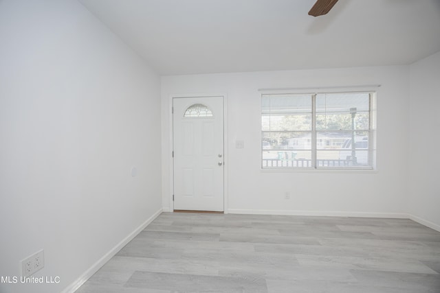 foyer entrance with ceiling fan and light wood-type flooring