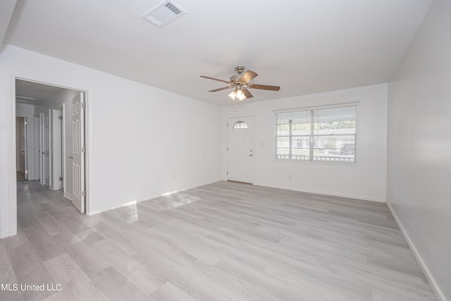 empty room with ceiling fan and light hardwood / wood-style floors