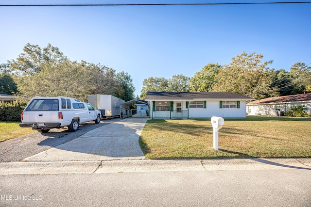 view of front of home featuring a front yard, a porch, and a carport