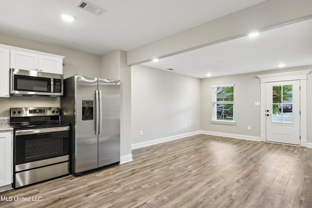 kitchen featuring white cabinetry, appliances with stainless steel finishes, and light hardwood / wood-style floors