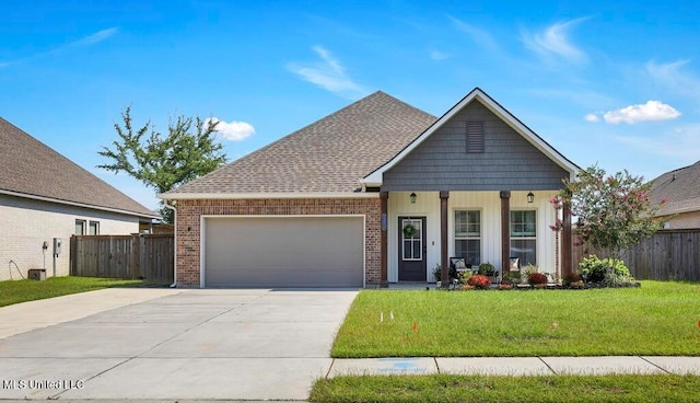 view of front of home with a garage and a front lawn