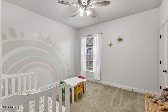 bedroom with carpet, ceiling fan, and a nursery area