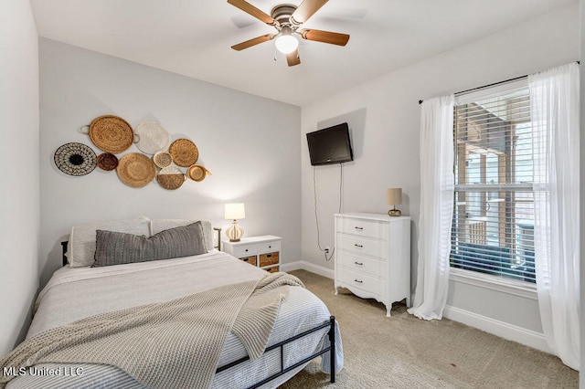 bedroom with ceiling fan and light colored carpet