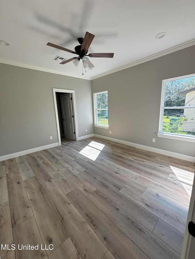 unfurnished room with crown molding, ceiling fan, and light hardwood / wood-style flooring