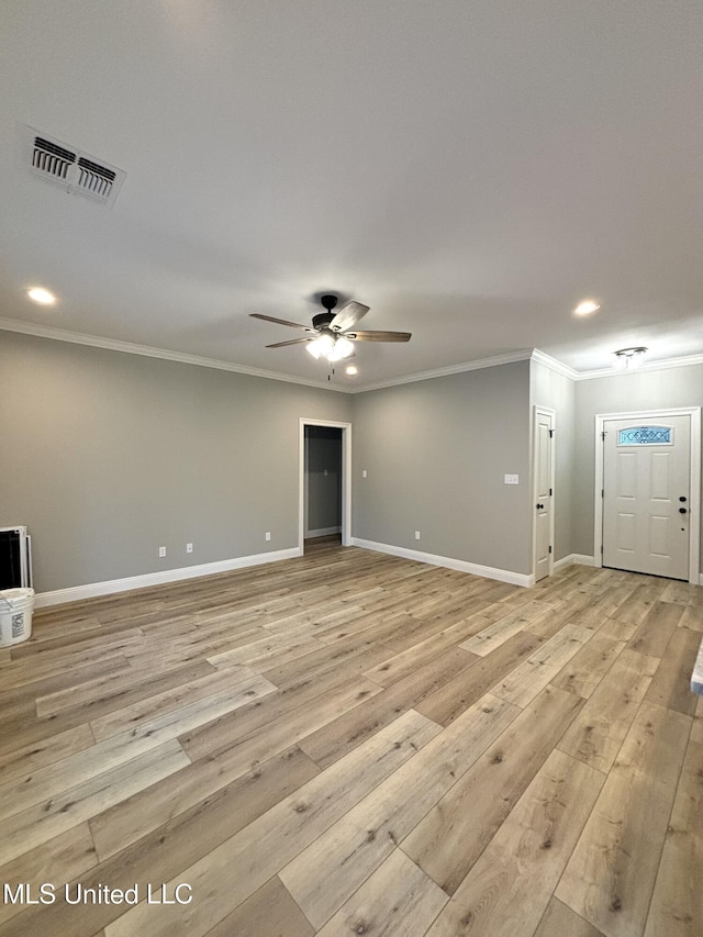 spare room with ceiling fan, ornamental molding, and light wood-type flooring