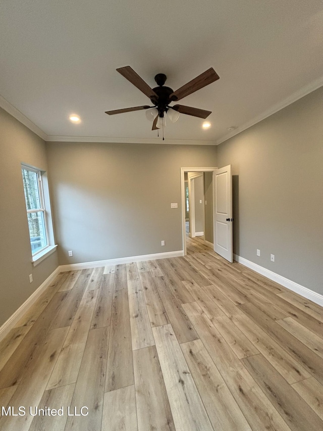 empty room featuring ornamental molding, ceiling fan, and light hardwood / wood-style floors