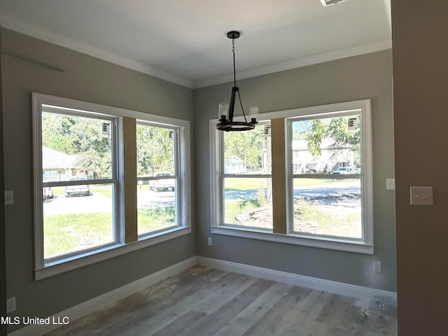 unfurnished dining area with crown molding and wood-type flooring