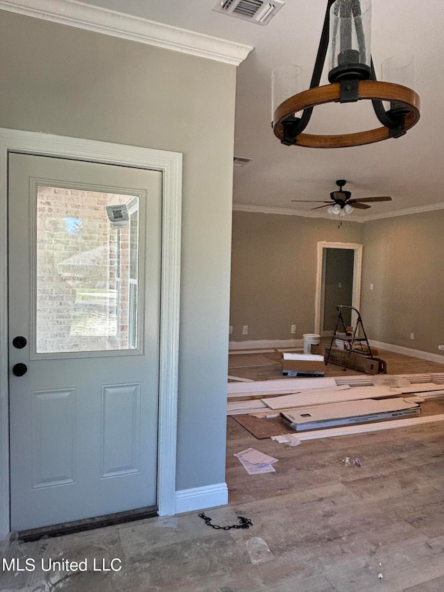 foyer with ornamental molding and ceiling fan