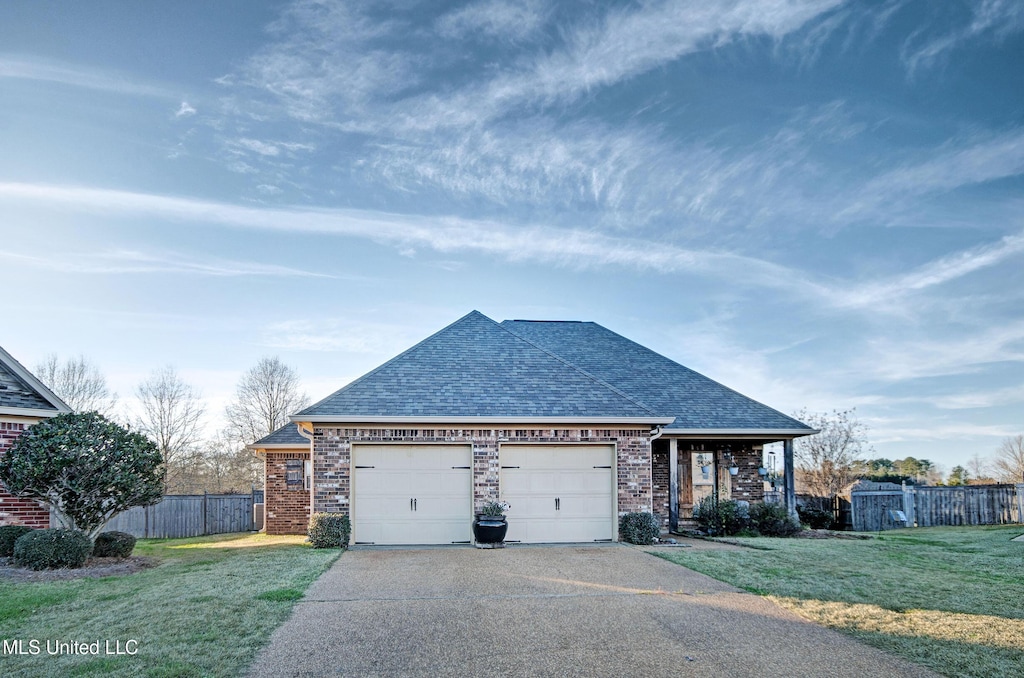 view of front of property with a front lawn and a garage