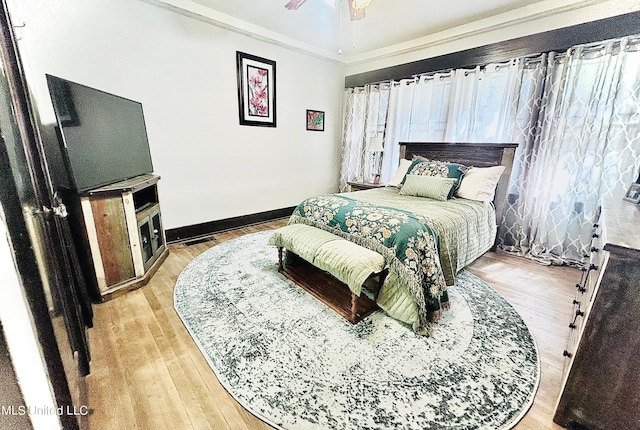 bedroom with ceiling fan and light hardwood / wood-style flooring