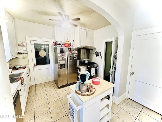 kitchen featuring light tile patterned flooring, white cabinetry, stainless steel appliances, and sink