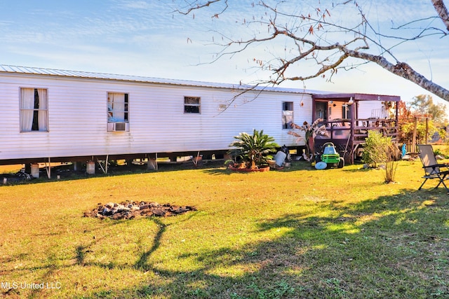 back of property featuring a yard and a deck