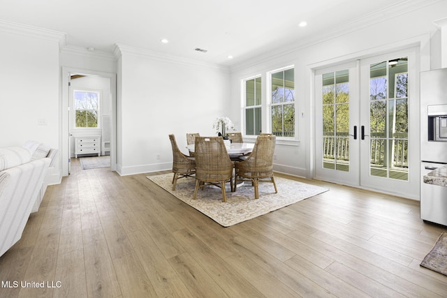 211 Chartres St, Bay Saint Louis, MS 39520 - dining area featuring french doors, ornamental molding, hardwood / wood-style flooring, recessed lighting, and baseboards