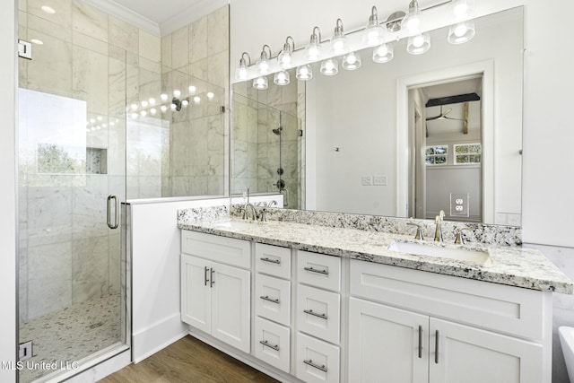 211 Chartres St, Bay Saint Louis, MS 39520 - full bathroom featuring a stall shower, double vanity, and wood finished floors