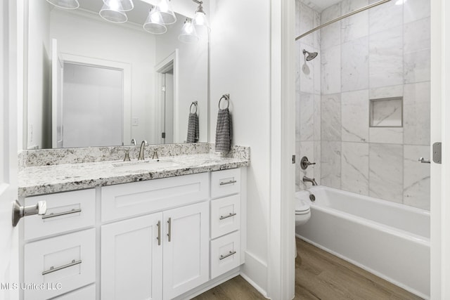 211 Chartres St, Bay Saint Louis, MS 39520 - bathroom featuring wood finished floors, shower / tub combination, vanity, and toilet