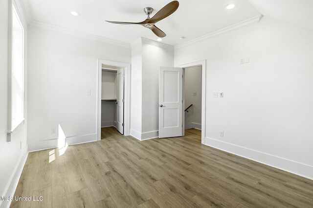 211 Chartres St, Bay Saint Louis, MS 39520 - unfurnished bedroom featuring ornamental molding, recessed lighting, baseboards, wood finished floors, and a spacious closet