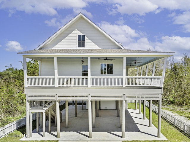 211 Chartres St, Bay Saint Louis, MS 39520 - view of front of property featuring a carport, a ceiling fan, roof with shingles, and fence